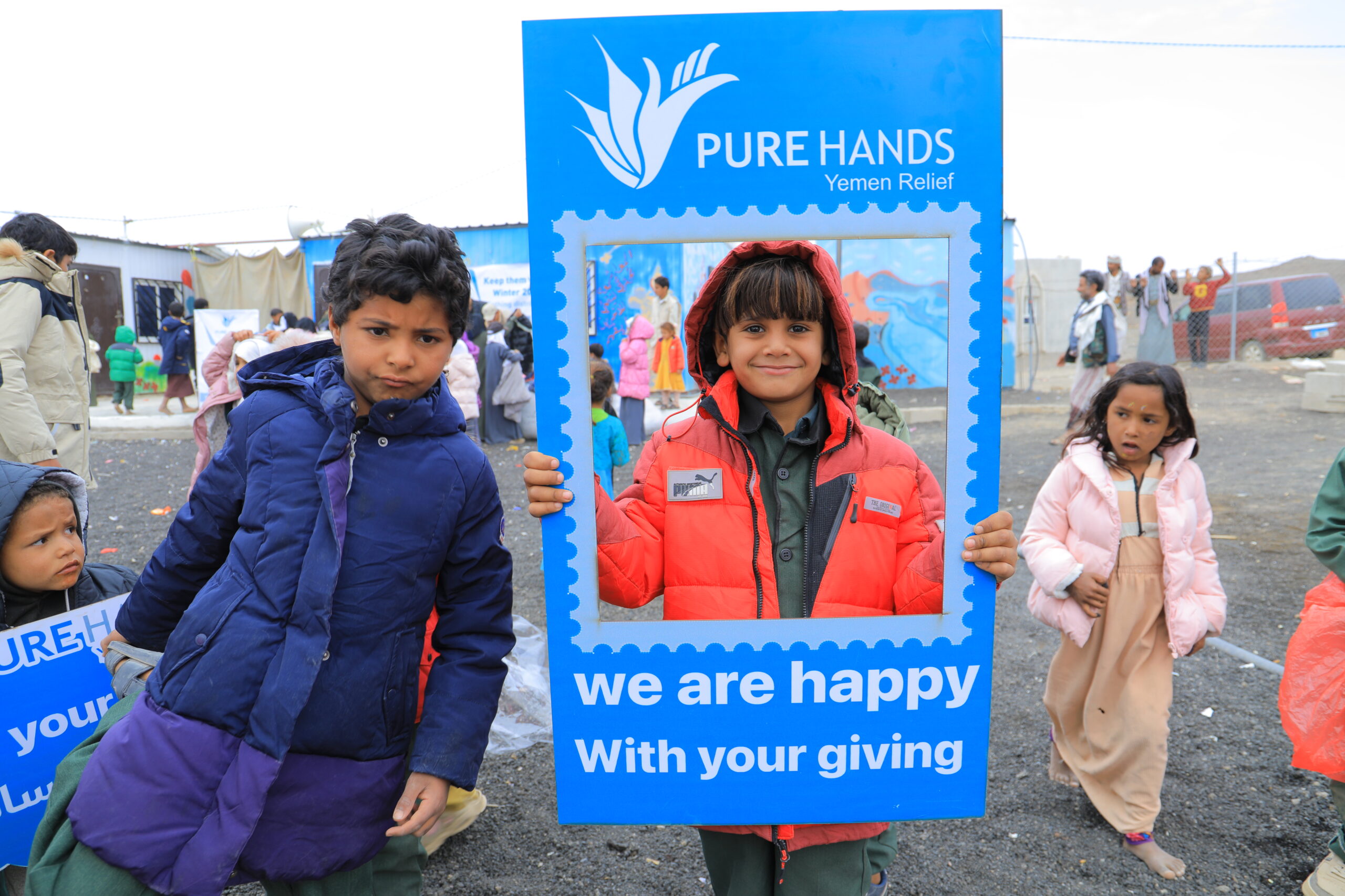 Children wearing winter jackets during a Pure Hands relief distribution in Yemen